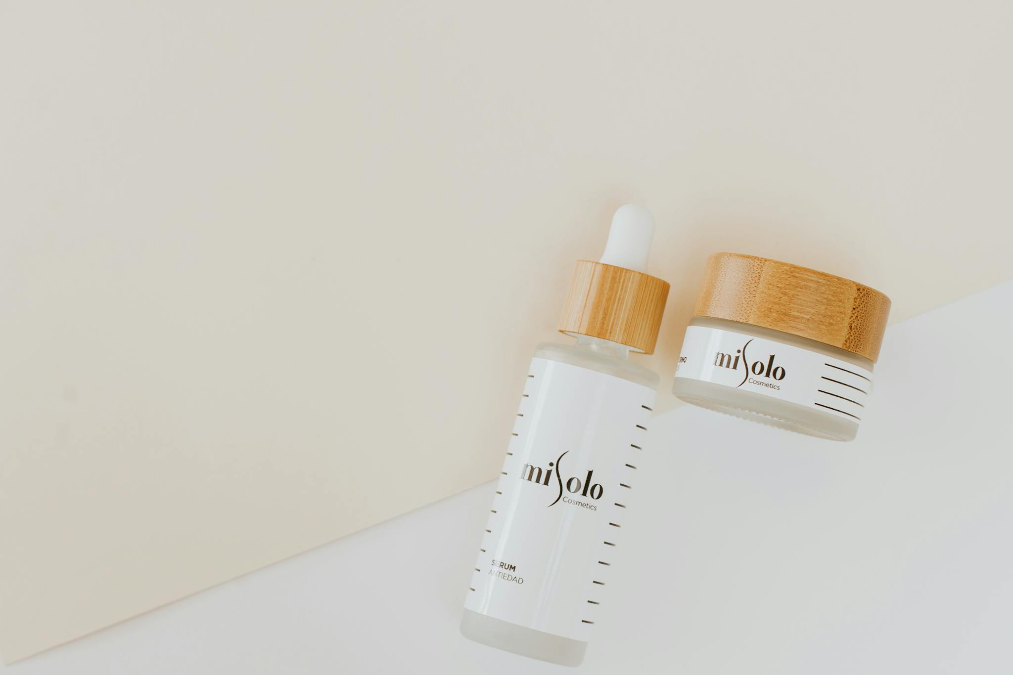 Elegant skincare products displayed in a minimalist style with bamboo lids.